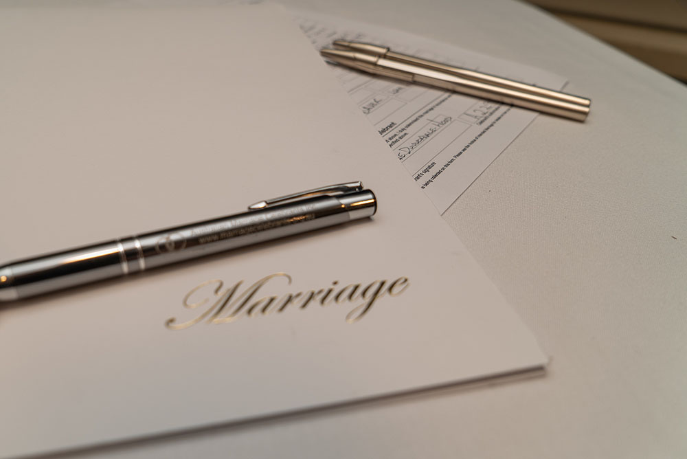 Marriage paperwork, pens - difference between a wedding planner and a wedding stylist